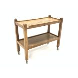 'Mouseman' Yorkshire oak tea trolley, two tiers raised on square supports terminating in castors, ca