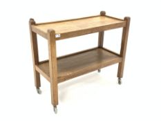 'Mouseman' Yorkshire oak tea trolley, two tiers raised on square supports terminating in castors, ca