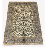 Persian fine Kashan ivory ground carpet, with repeating floral motif enclosed by multi line border,