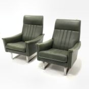 Pair of continental armchairs, upholstered in green leather, with loose cushions, raised on flat bar