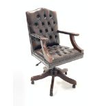 20th century captains chair, seat and back upholstered in buttoned and studded brown leather, open a