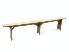 19th century rustic elm narrow bench, with three shaped panel supports, L235cm, H47cm, D21cm