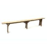 19th century rustic elm narrow bench, with three shaped panel supports, L235cm, H47cm, D21cm