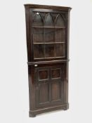 Early 19th century mahogany floor standing corner cupboard, dentil cornice over gothic arched astrag