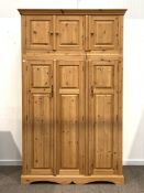 Pine triple wardrobe, with three cupboards over three full length cupboards enclosing interior fitte