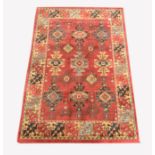 Persian design Heriz red ground rug, with repeating medallion on red field, enclosed by guarded bord