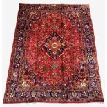 Large Persian fine Tabriz red ground carpet, central medallion on busy red field, with stylised fol