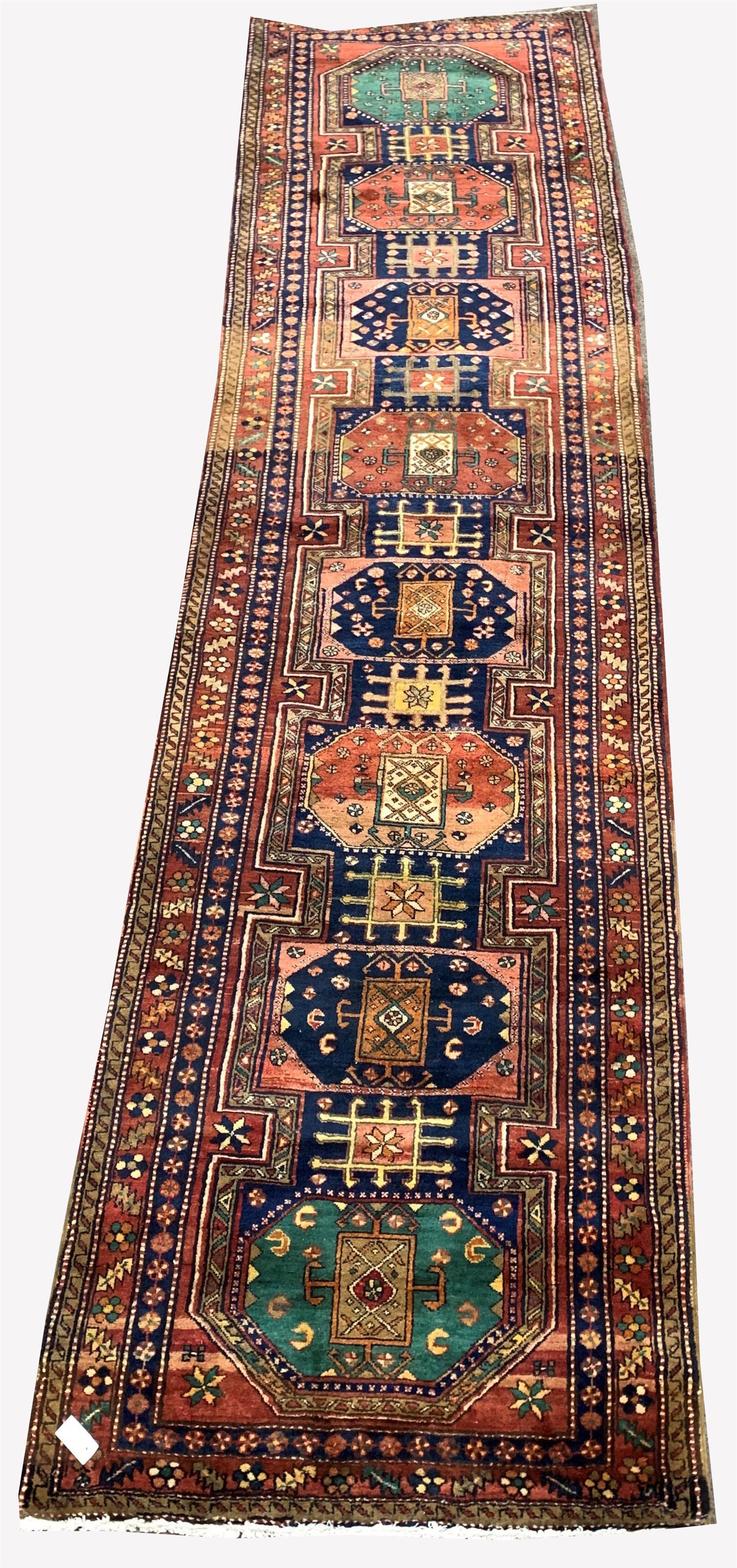 Large Persian Karajeh red ground runner, eight lozenges in green blue and red, decorated with geomet