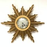 Elliot Giltwood starburst wall clock with silvered dial and Roman numeral chapter ring, retailed by