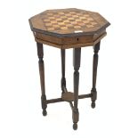 Victorian walnut games table, the octagonal top inlaid with rosewood and boxwood games