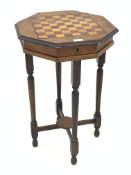 Victorian walnut games table, the octagonal top inlaid with rosewood and boxwood games