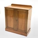 Early 20th century mahogany two door cupboard, with raised back and two fixed shelves, skirted base,