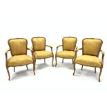 Set four French beech open armchairs, the exposed moulded frame decorated with floral carvings, arm