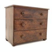 Early 20th century scumbled hardwood chest fitted with three long drawers, raised on compressed bun