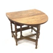 Early 20th century oak drop leaf table, oval top with moulded edge raised on spiral turned supports,