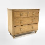 Early 20th century pine chest fitted with two short and two long drawers, raised on turned supports,