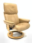 Stressless reclining armchair upholstered in tan leather, (W78cm) together with a matching footstool