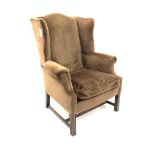 Georgian design wing back armchair, upholstered in brown velvet with loose cushion, raised on square