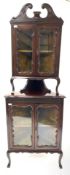 Georgian style walnut floor standing two tier corner cupboard, with acanthus carved swan neck pedime