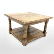 Solid oak coffee table, with square top raised on turned and block supports, united by under tier, 7