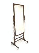 Early 20th century oak framed cheval mirror, geometric bevelled plate on rope twist supports, raised