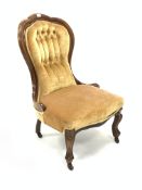 Late Victorian mahogany spoon back upholstered chair, covered in buttoned yellow velvet, raised on c