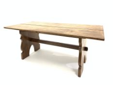 Early 20th century hardwood refectory style table, the rectangular top raised on shaped panel end su