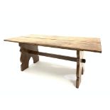 Early 20th century hardwood refectory style table, the rectangular top raised on shaped panel end su