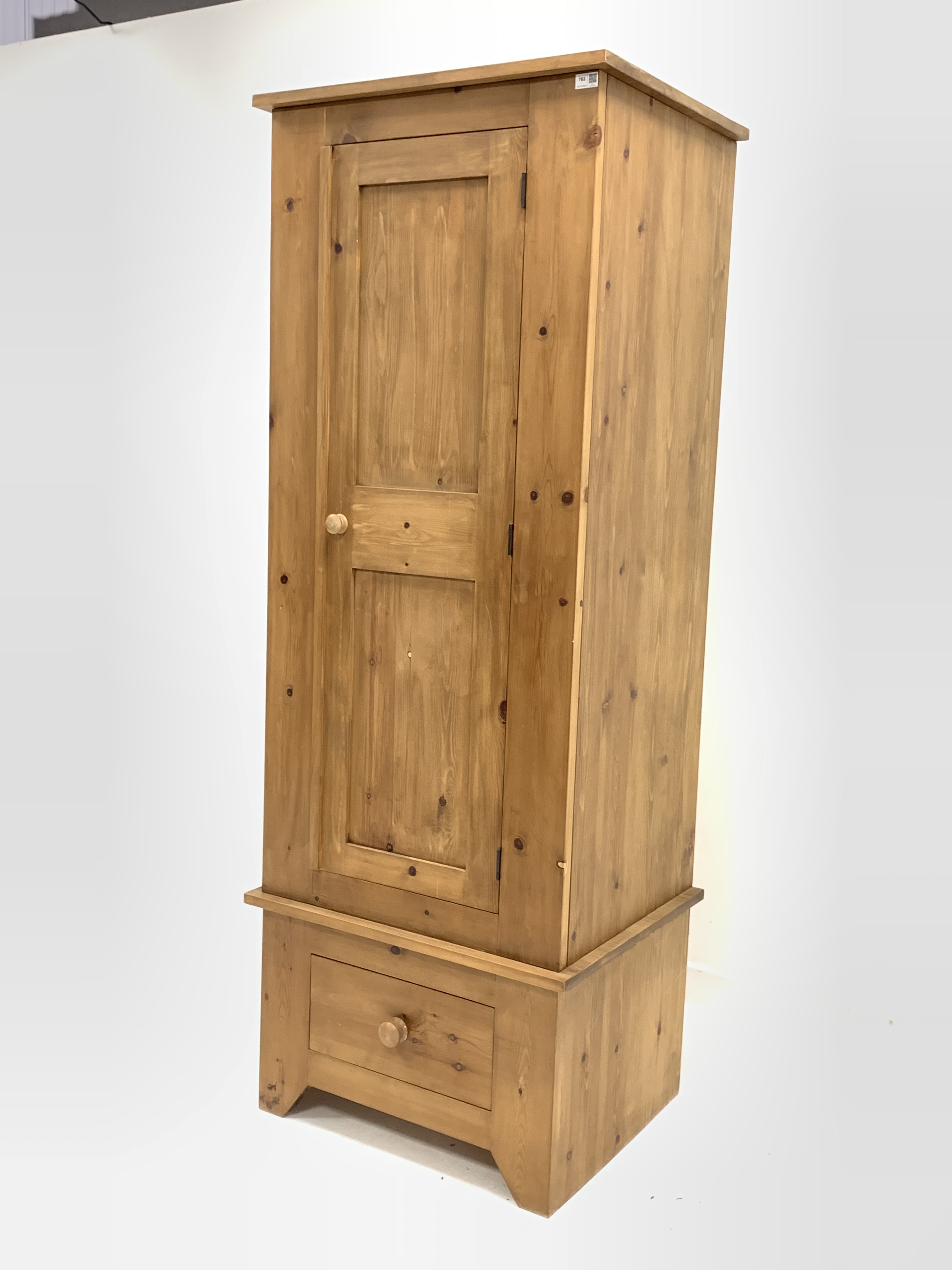 Narrow pine single wardrobe, panelled door enclosing interior fitted with hanging rail, over drawer, - Image 2 of 2