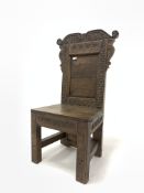 Carved oak Wainscot style chair, with scrolled cresting rail over floral roundels, panelled seat, ra