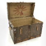 Early 20th century American steamer trunk, leather and metal bound, with scraps of old paper labels,