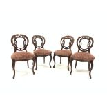 Set of four Victorian mahogany side chairs, with floral and scroll carved open back over upholstered