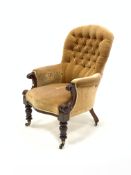 Late Victorian walnut upholstered armchair of generous proportion, covered in buttoned yellow velvet