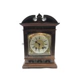 Late 19th century mantle clock in architectural walnut case, arched pediment with central leaf carve