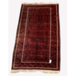 Red afghan rug, with six panels on red field, geometric decoration to border, 204cm x 113cm