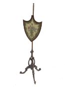 Late 19th century walnut pole screen, shield shaped screen with needle work panel, carved c scroll s