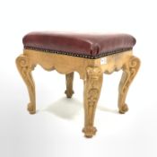 20th century carved oak footstool, with studded faux leather upholstered top over shaped apron and