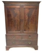 Georgian mahogany linen press with dentil cornice over blind fret work frieze, two panelled doors en