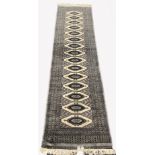 Afghan design Bokhara ground runner rug, with repeating gul motif on grey field, enclosed by multi l