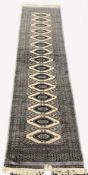 Afghan design Bokhara ground runner rug, with repeating gul motif on grey field, enclosed by multi l