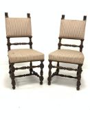 Pair of early 20th century carved oak chairs, with lion mask finials over upholstered seat and back