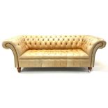 Late 20th century three seat Chesterfield sofa, upholstered in deep buttoned tan leather, raised on