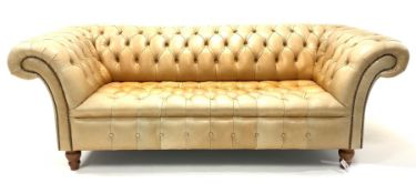 Late 20th century three seat Chesterfield sofa, upholstered in deep buttoned tan leather, raised on