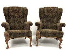 Pair of Queen Anne style wing back upholstered armchairs, raised on shell carved walnut cabriole fro