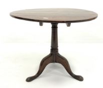 Georgian oak circular tilt top occasional table, raised on ring turned column and triple splay suppo