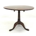 Georgian oak circular tilt top occasional table, raised on ring turned column and triple splay suppo