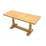 'Mouseman' Yorkshire oak oblong occasional table, with adzed top raised on octagonal turned supports