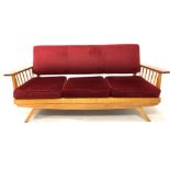 Mid 20th century retro elm and beech three seat sofa, with red velvet upholstered back and loose cus