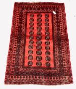 Persian design red ground rug, repeating gul motif on red field enclosed by multi line border,100cm