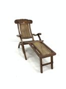 Early 20th century teak folding steamer chair, leaf scroll carved cresting rail, cane back and foot